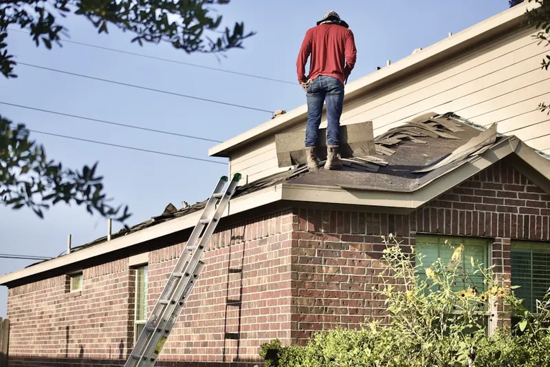 Professional roofer working on a residential roof in Opequon